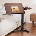Tiltable Mobile Small Standing Desk, Pneumatic Adjustable Height Overbed Bedside Table with Wheels, Sit Stand Portable Rolling Laptop Desk Computer Workstations, Walnut